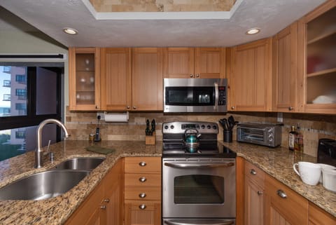 Oceanview from the kitchen, with oven range, sink, and microwave.