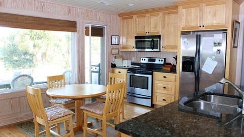 This spacious kitchen has granite counters and stainless appliances.