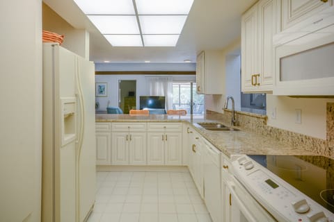 Fully equipped kitchen of this villa in New Smyrna Beach with access into the morning room and modern amenities.