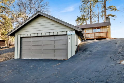 Welcoming cabin entry surrounded by towering pine trees, offering fresh mountain air and a peaceful forest setting—the perfect first impression for your Big Bear Lake getaway.