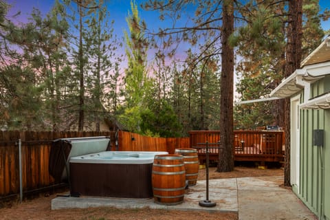 Private outdoor hot tub, surrounded by tall pines, perfect for relaxing under the trees after a day of adventure—enjoy peaceful forest views, fresh air, and a truly rejuvenating stay.