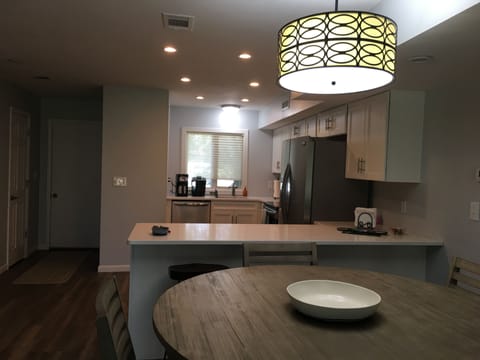 Dining room table & kitchen. 3 more stools available for additional seating.
