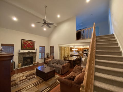 Living room area with stairs to second floor loft 