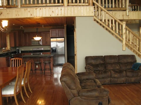 Open layout living room, dining room, kitchen, and stairs to the loft.