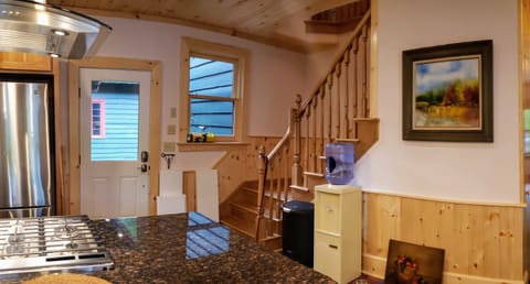 Brand new hickory staircase leads from kitchen to renovated hall.