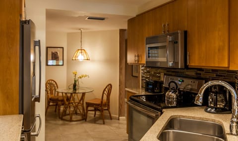Granite kitchen with adjacent breakfast area and washer-dryer