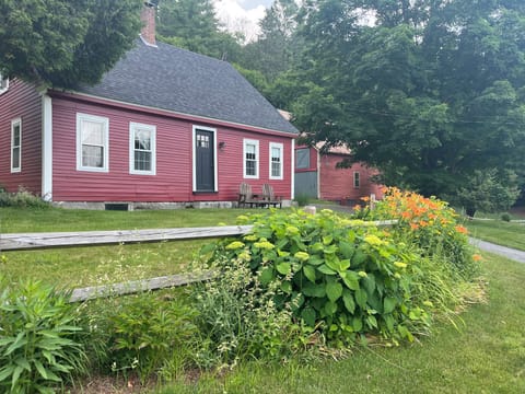 Historic Vermont farmhouse surrounded by beautiful gardens and country charm