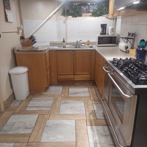 View of  kitchen with range, toaster,  and microwave.