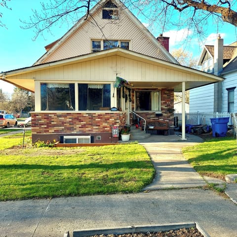Straight on view of our home in early summer with view of front porch.