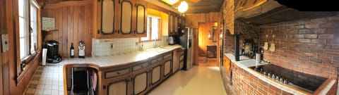 Galley kitchen with modern top of the line appliances- next to the dining room