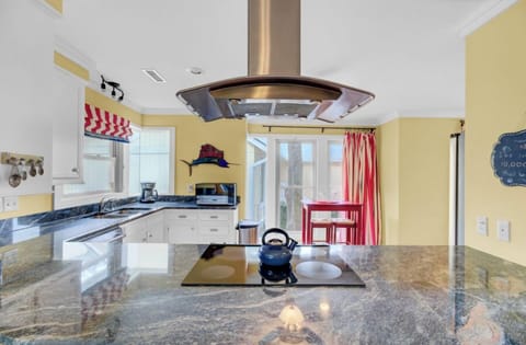 Your spacious kitchen awaits with gleaming granite counters, modern appliances, and cheerful yellow walls that make cooking feel like pure joy.