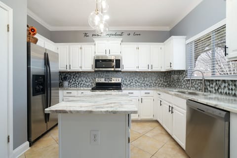 Open concept kitchen, perfect for gathering and socializing. 