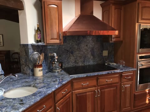 Wolf appliances, copper hood,  blue granite counter tops & backsplash