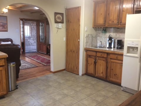 Kitchen, to living room, to entry door. Coffee pot and Keurig coffee maker