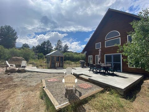A closer view of the fenced in yard and patio to relax on during your vacation! 