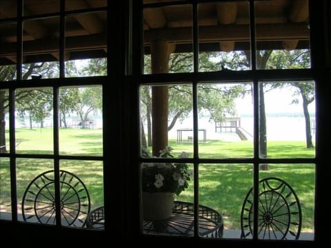 View from the master bedroom of porch table and chairs, gazebo & dock in center 