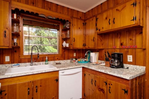 Full kitchen in a country feeling space. Coffee maker and dishwasher too.