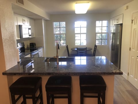 Kitchen W/Large Counter Top and Bar.