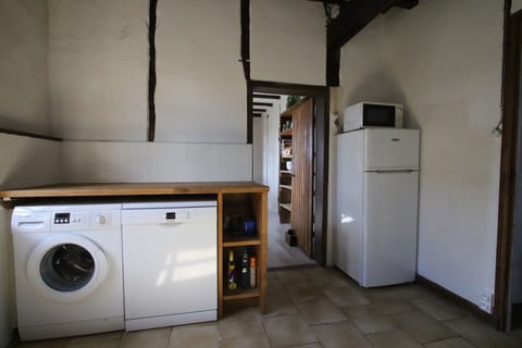 Scullery with dish washer, washing machine, fridge and microwave