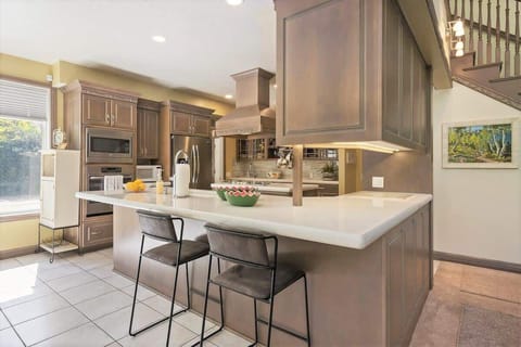 Open concept wrap-around bar with beautiful custom cabinetry