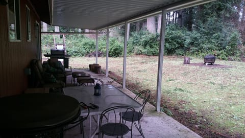 Back covered patio with fire pit and grill.