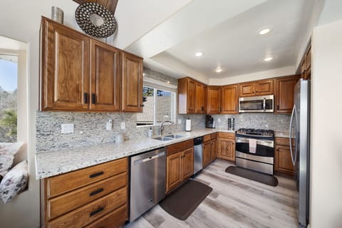 Fully-stocked kitchen -stainless steel appliances-granite countertop &backsplash