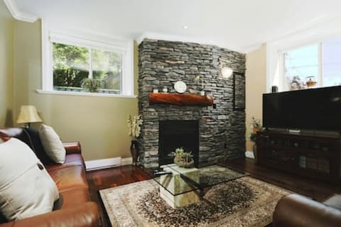 Front living room with floor to ceiling rock fireplace.