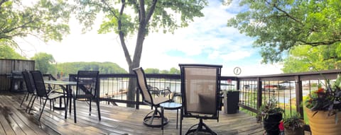 Large deck with grill, table, and seating. An umbrella is available too.