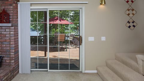 View from walk-out lower level bar area to large lower level deck area.