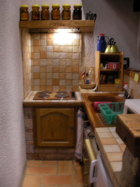 Kitchen corner behind bar-style counter in main room.
