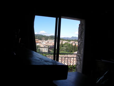 Balcony window view from bar-counter over the downtown and hills in distance.