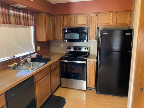 Fully applianced kitchen including clothes washer and dryer.