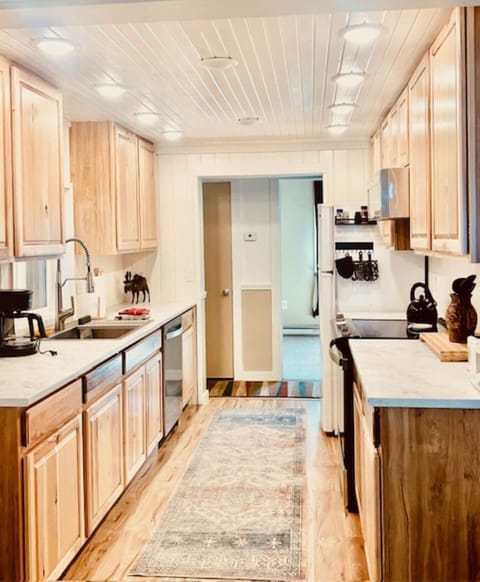 Renovated kitchen with new appliances and cabinets.