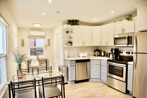 Kitchen fully stocked w/ tableware. Fridge, microwave, stove, oven, & dishwasher