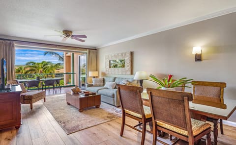 Living room and dinning area - Bright and comfortable living area with plush seating and a large flat-screen TV