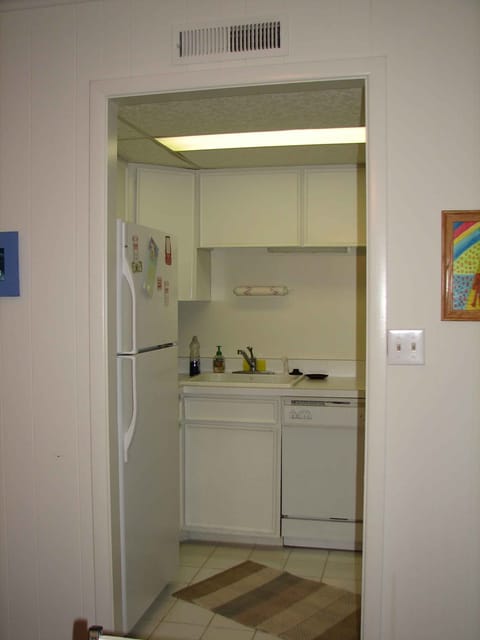 The kitchen is equipped with dishes, cookware, coffee maker, microwave, toaster.
