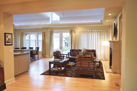 Well lit living room area looking out to the backyard.