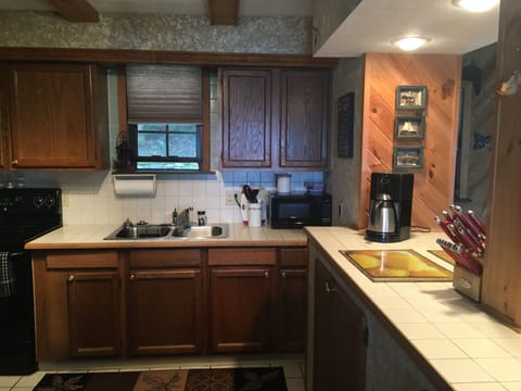 Kitchen with full size fridge/freezer, electric stove, microwave, etc.