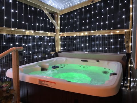 covered and screened in hot tub on lower back deck