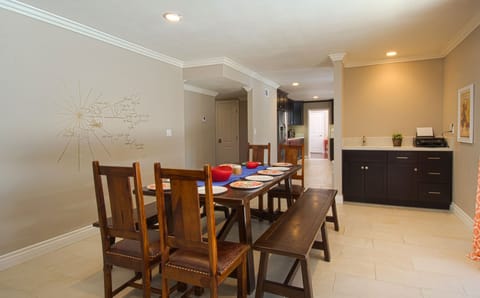 - Bright dining area with wooden furniture and seating for groups   - Convenient location next to living room for shared meals   - Spacious design perfect for family dining and celebrations
