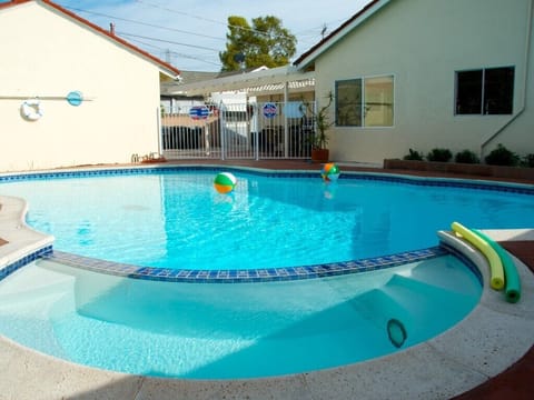 - Sparkling pool with easy entry steps perfect for family swims   - Bright backyard with plenty of sunshine for outdoor enjoyment   - Private pool with playful setting ideal for kids and group fun