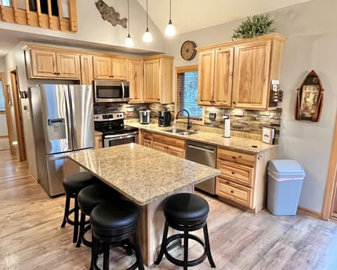 Renovated open kitchen, granite countertops & seating for up to 14 to eat.   