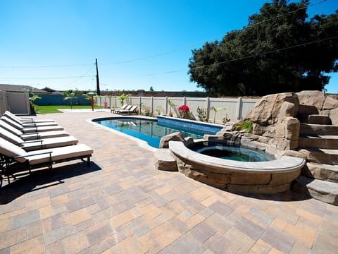 - Relax by the private pool with spa and lounge chairs for ultimate comfort   - Spacious outdoor area perfect for families and groups to unwind together   - Sunny backyard retreat with swimming pool for fun-filled vacation days