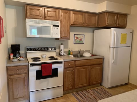 Kitchen with everything you need:silverware, Dishes, pots, pans and coffee pot. 