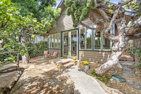 Front Courtyard with sitting area surrounded by trees and flowers. 