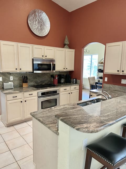 Fully stocked with gleaming granite counters and stainless steel appliances.