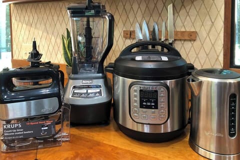 The cabin has lots of appliances: Kitchenaid Stand Mixer, Beaters, Food Processor, Blender, Instant Pot, Stick Blender, Microwave, On Demand Hot Water Dispenser, Burr Coffee Grinder, Moka Pot, Milk Frother, French Press, Mr. Coffee, and more!