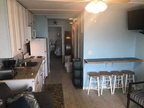 Hall Bath to right, Bedroom straight ahead, Kitchen, Eating bar, Family room.