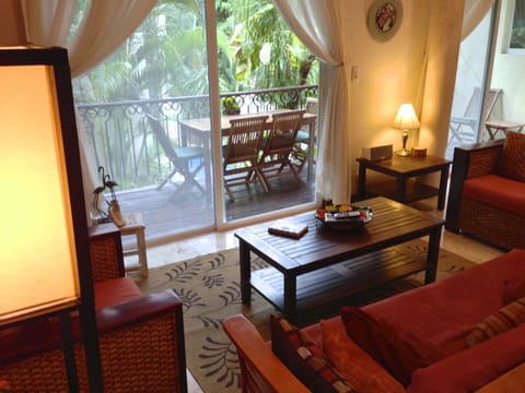 Living Area and Large Balcony overlooking pool and gardens.