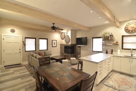 Spacious main room with IKEA kitchen, cozy gas fireplace and comfortable couch.
